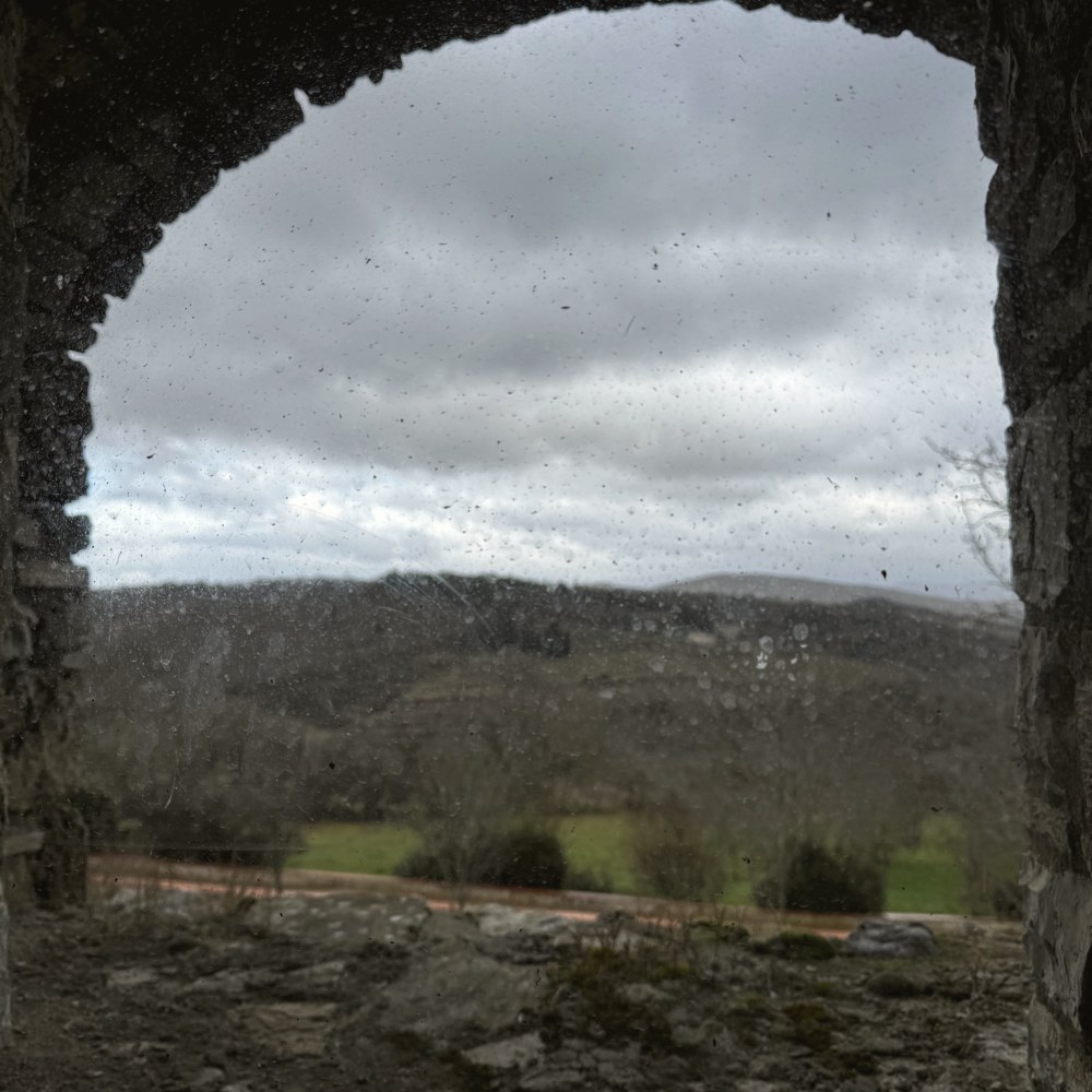 A stone archway framing the hills