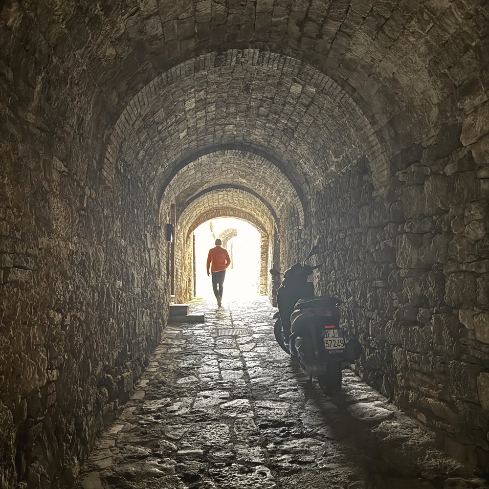 A stone tunnel opening to the light